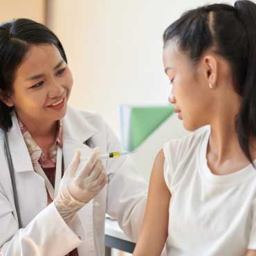 Doctor giving child a vaccine