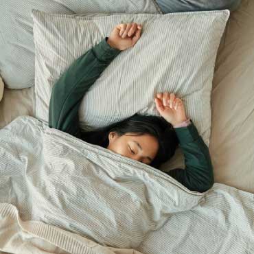 Person sleeping in bed.