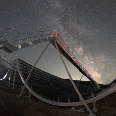 A view of CHIME at night, with the Milky Way in the background
